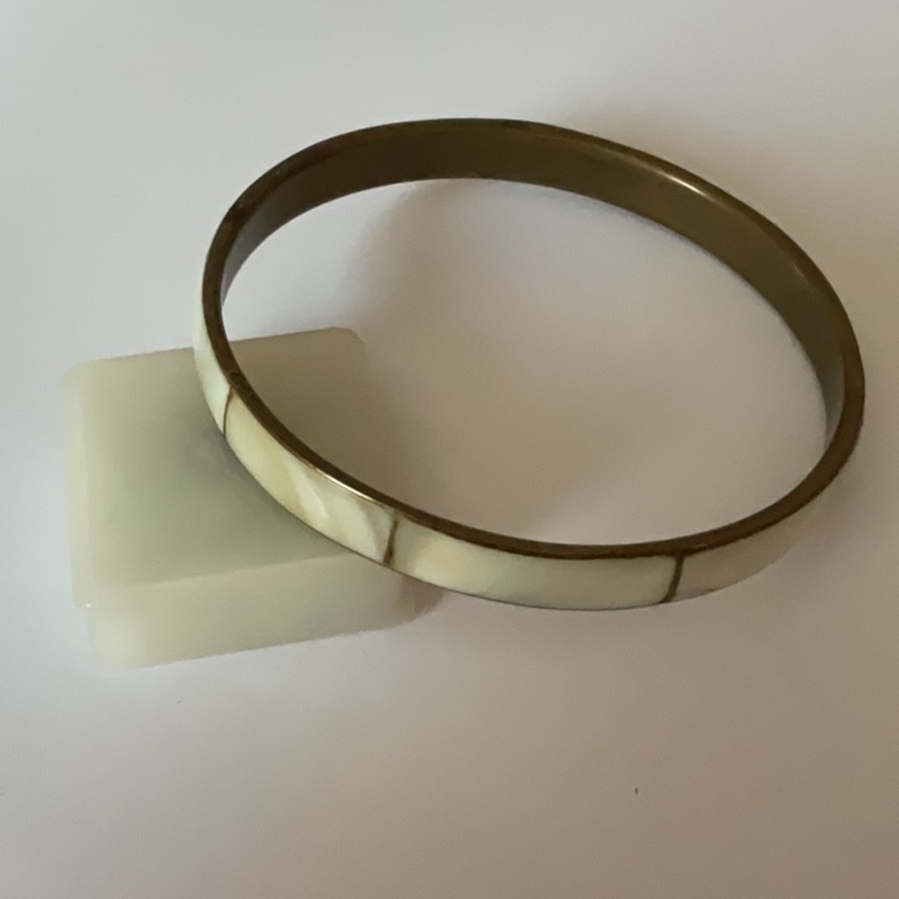 Chic Cream and brass Bangle along with teal stretch bracelet.